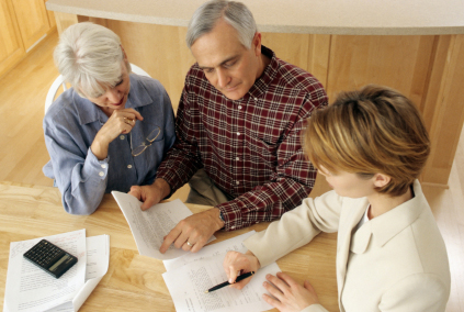 senior couple at table looking through papers